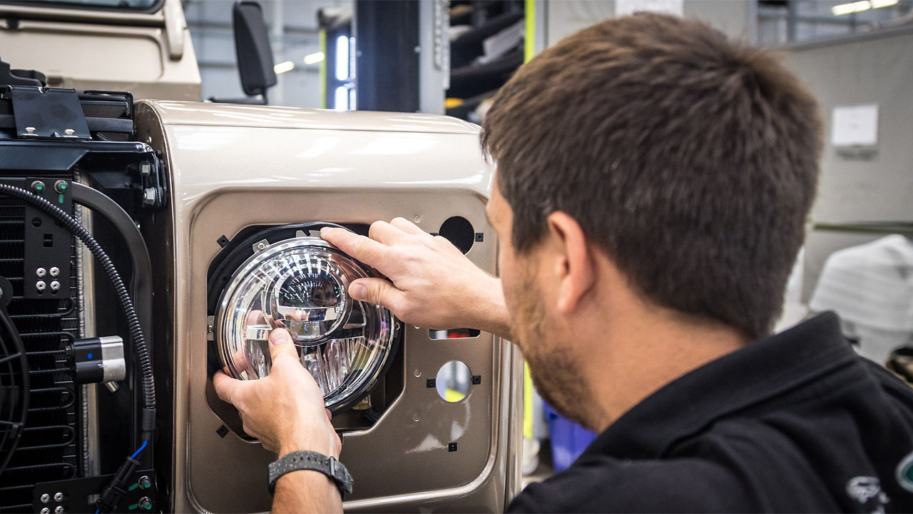 classic Defender Technician fixing front light