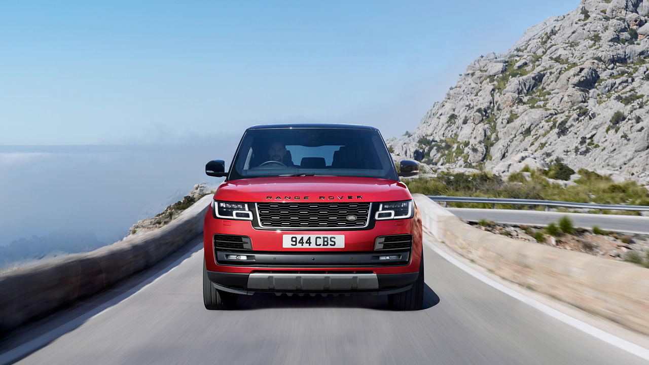 Range Rover driving on mountain runway road