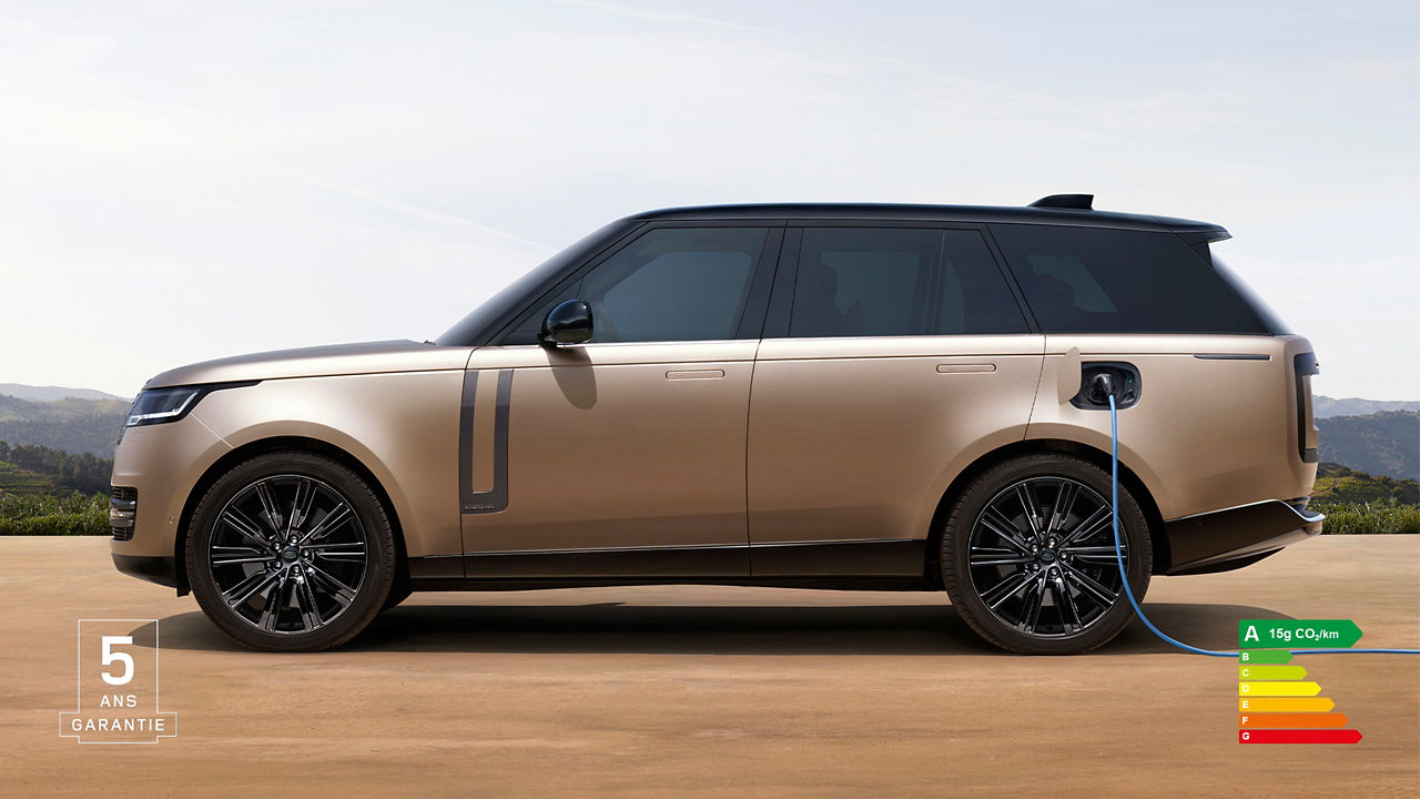 Side view of Range Rover PHEV in Sunset Gold charging batteries with energy efficiency label A (15g CO2/km) and 5 years warranty watermark.