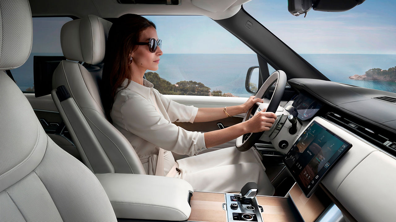 Women driving Range Rover side view