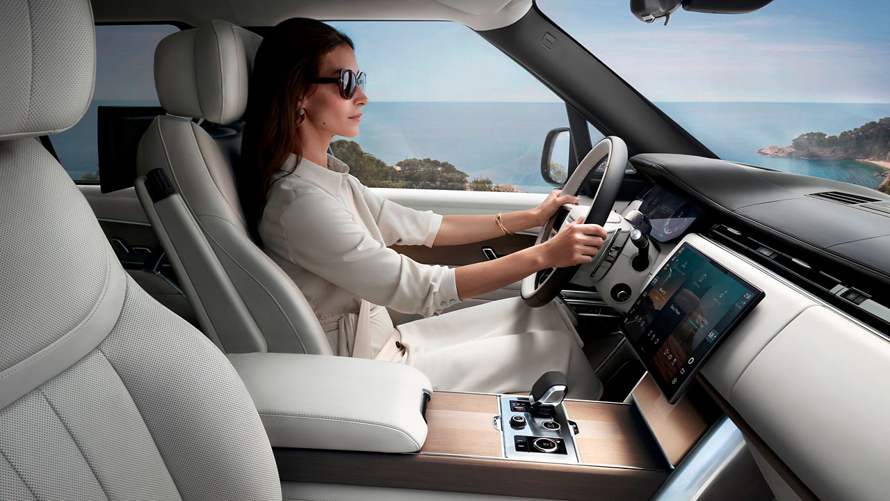 Women driving range rover