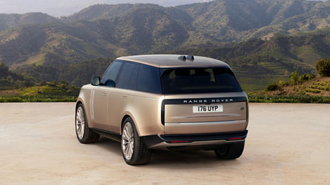 Range Rover parked in front of the mountains