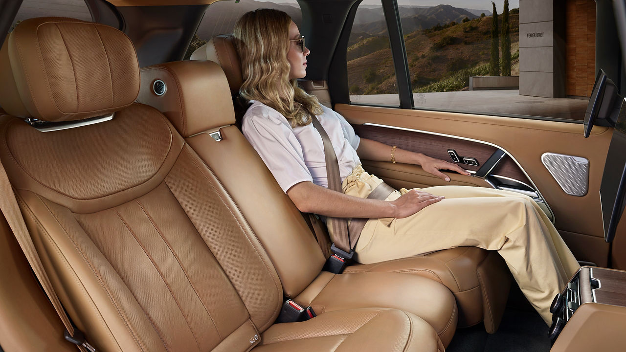 Woman sitting in the New Range Rover with light brown interior