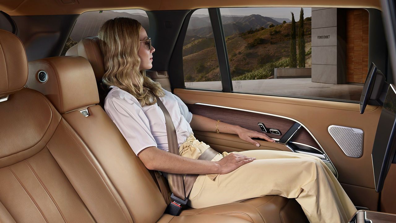 Woman sitting in the New Range Rover with light brown interior