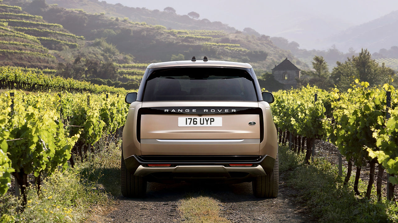 The New Range Rover driving through the countryside.