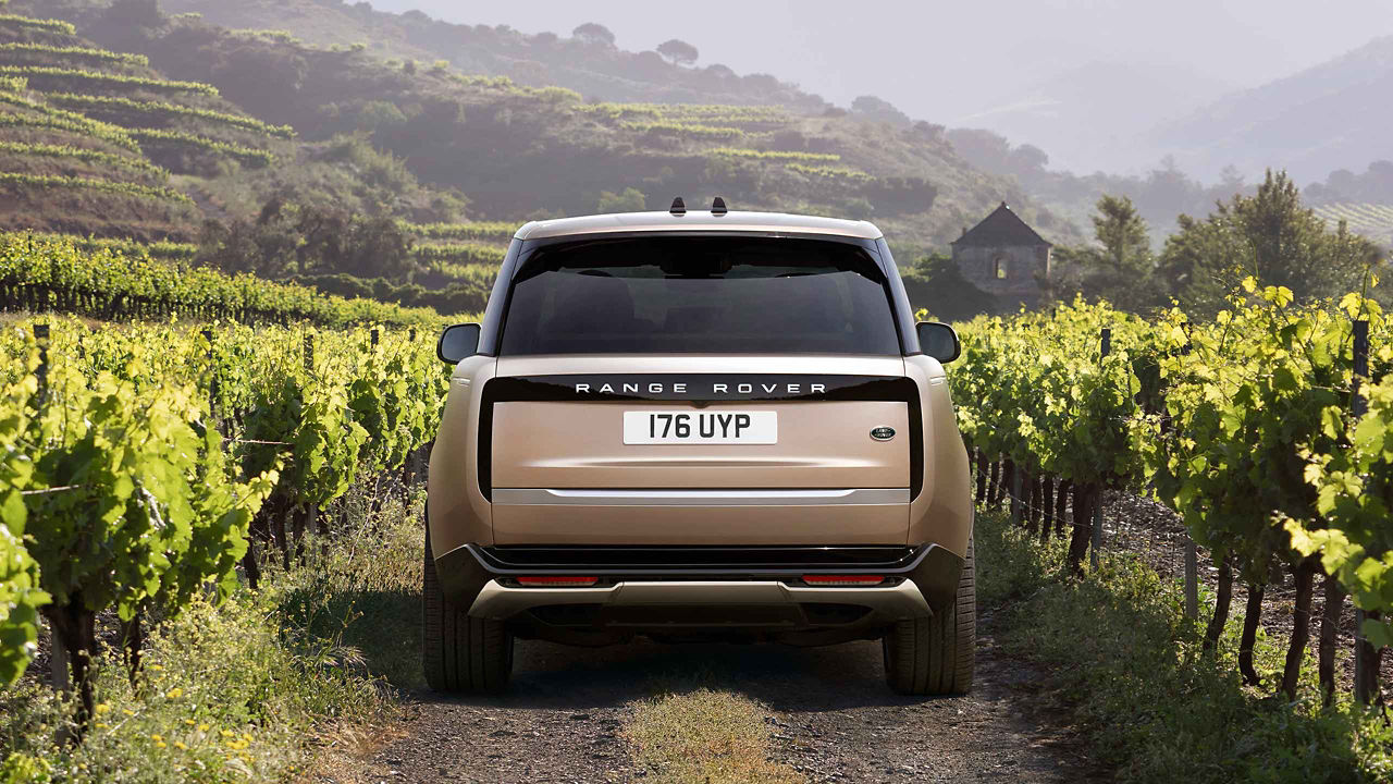 The New Range Rover driving through the countryside.