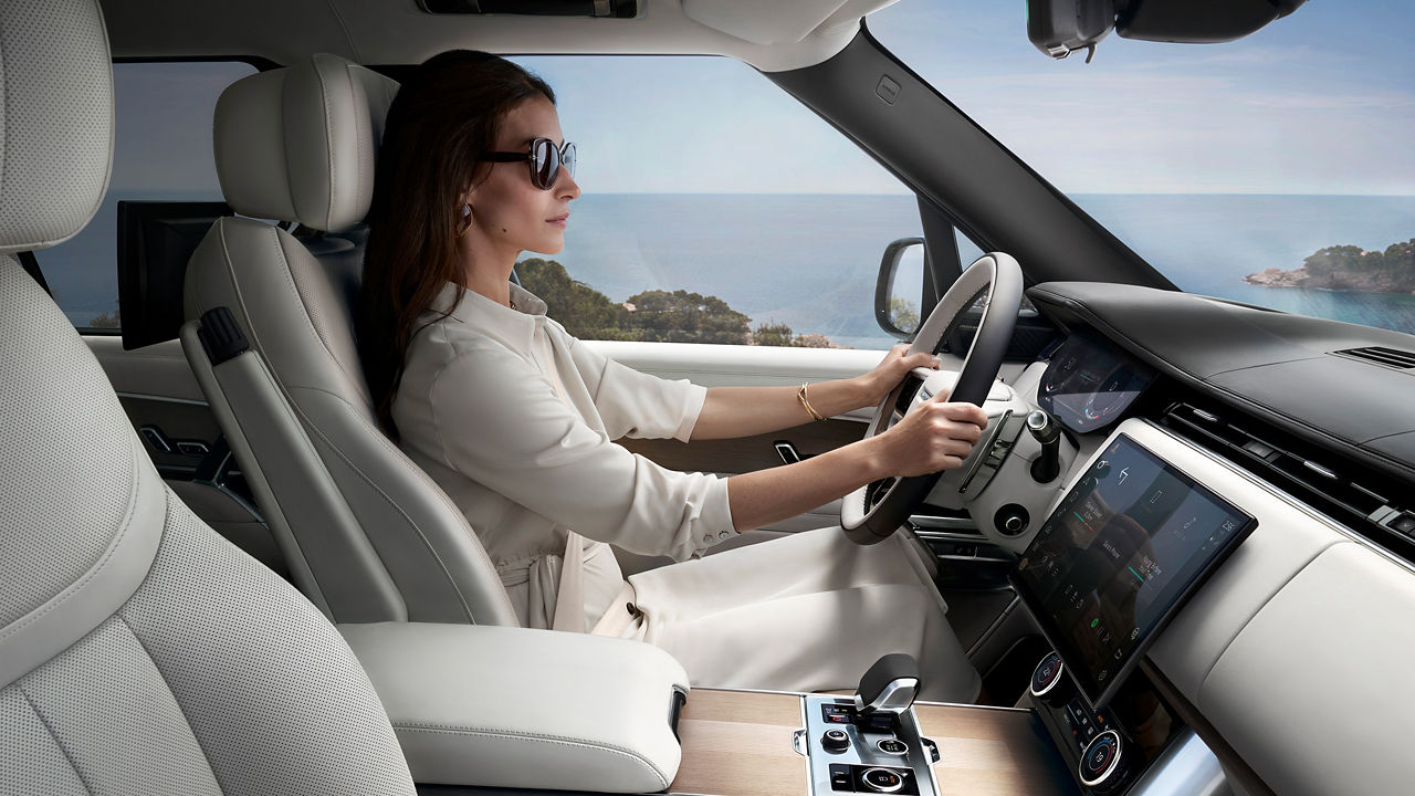 Close-up of girl driving modern luxury car