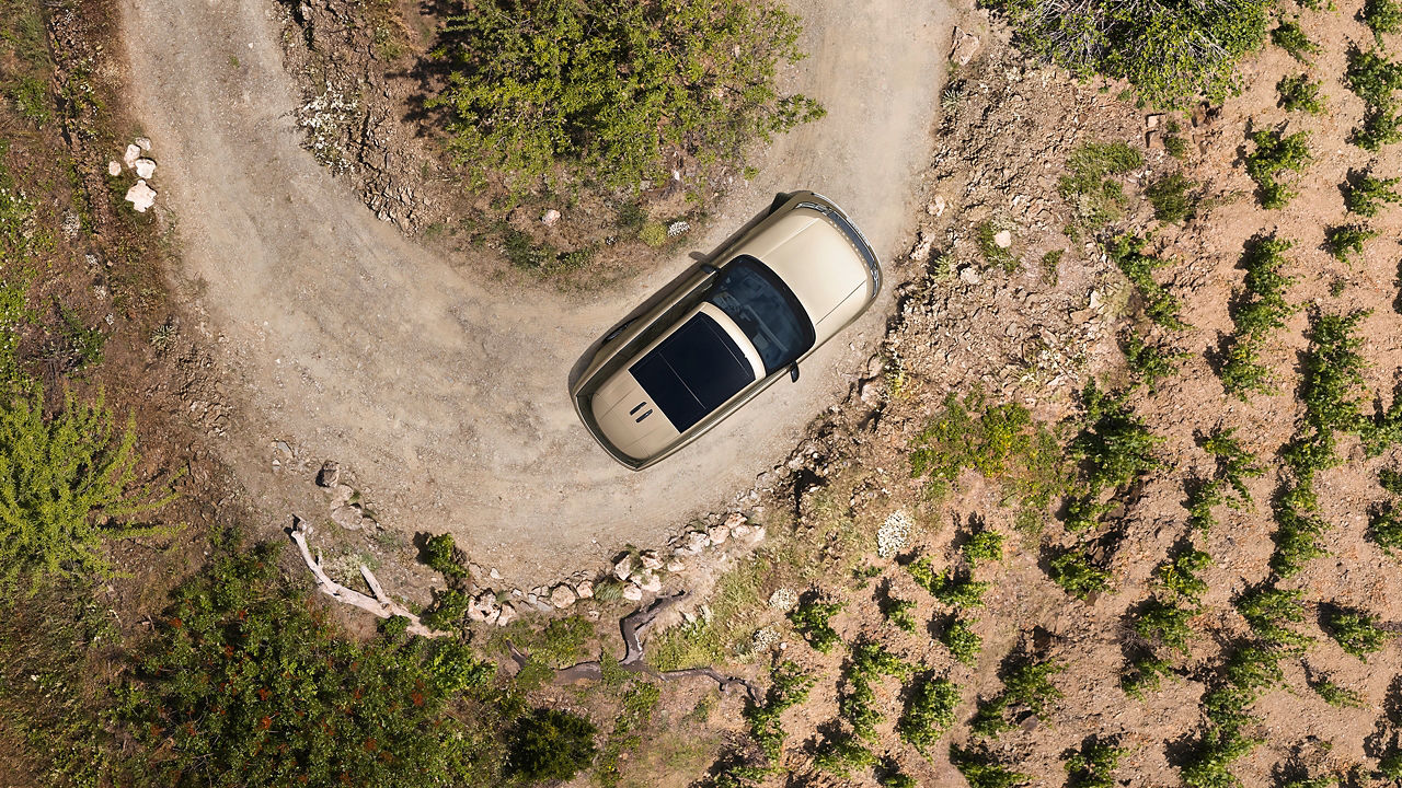 Range Rover down climbing on mountain runway road