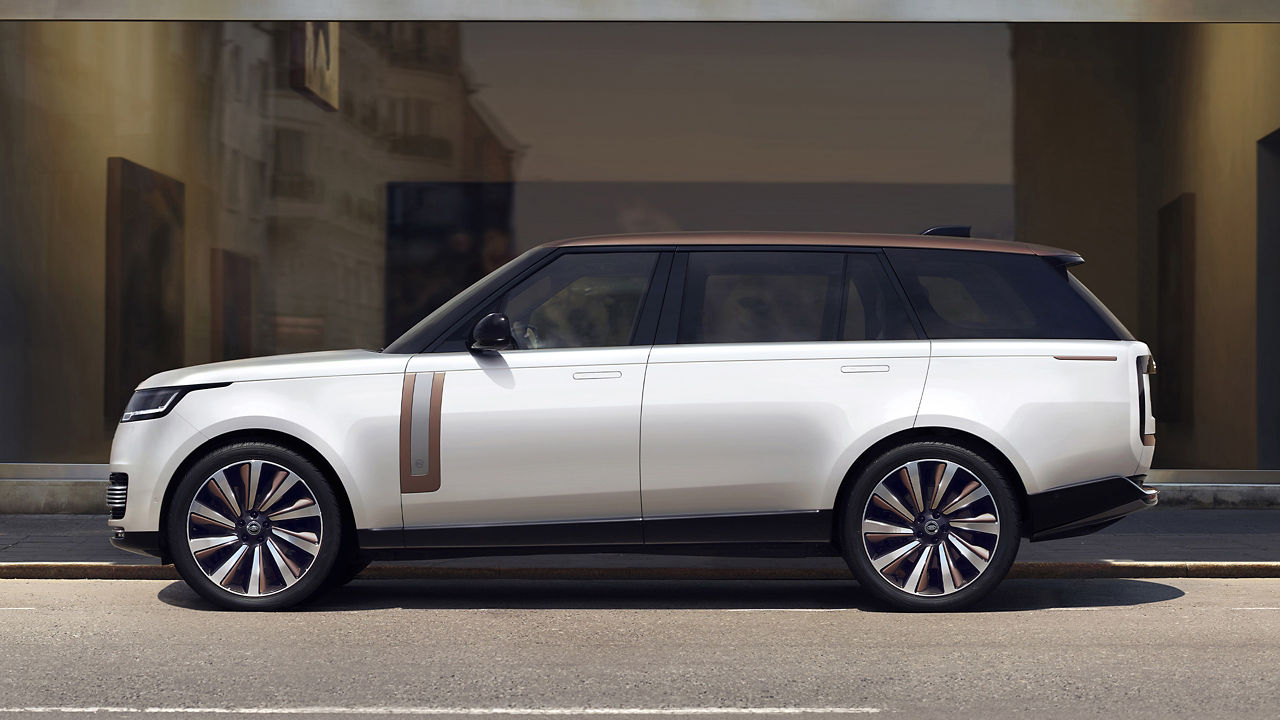 Parked New Range Rover outside of glass building