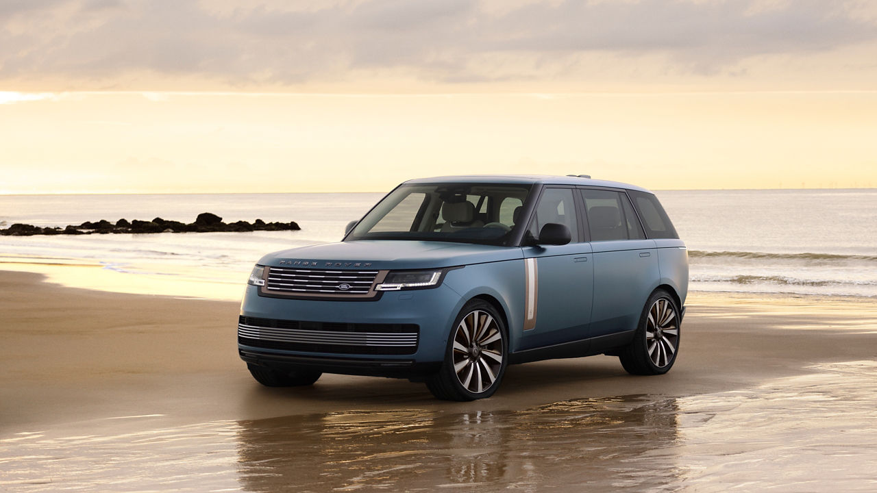 Range Rover Bespoke Blue Satin driving on sand at the beach