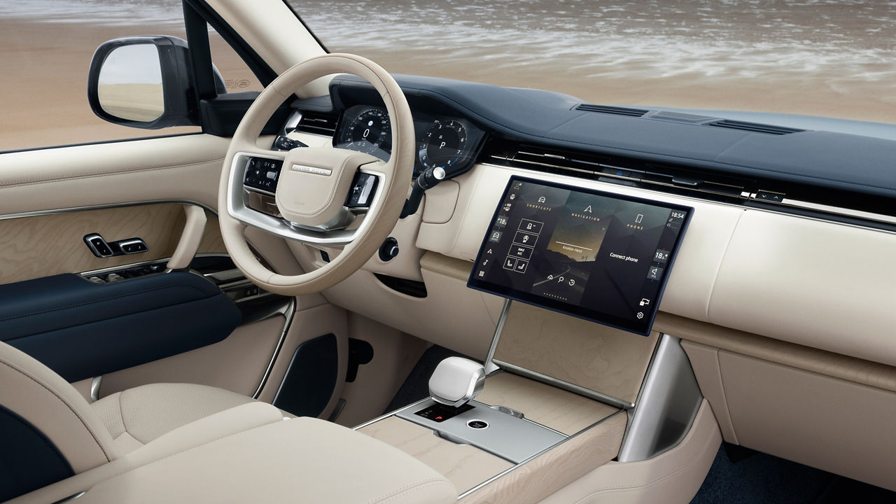 Interior side view of Range Rover Bespoke Blue Satin at the beach