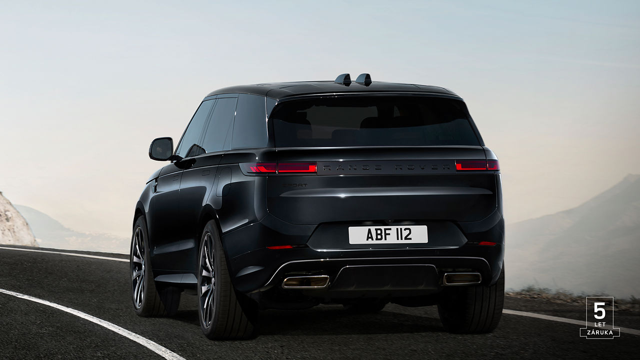 Rear view of Range Rover Sport in Santorini Black driving on road with 5 years warranty watermark.