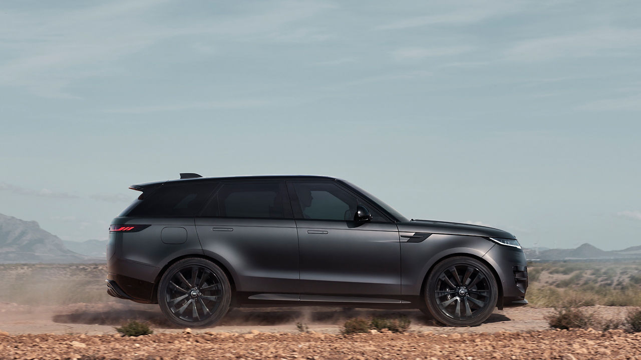 Side view of Range Rover Sports on Hill Road