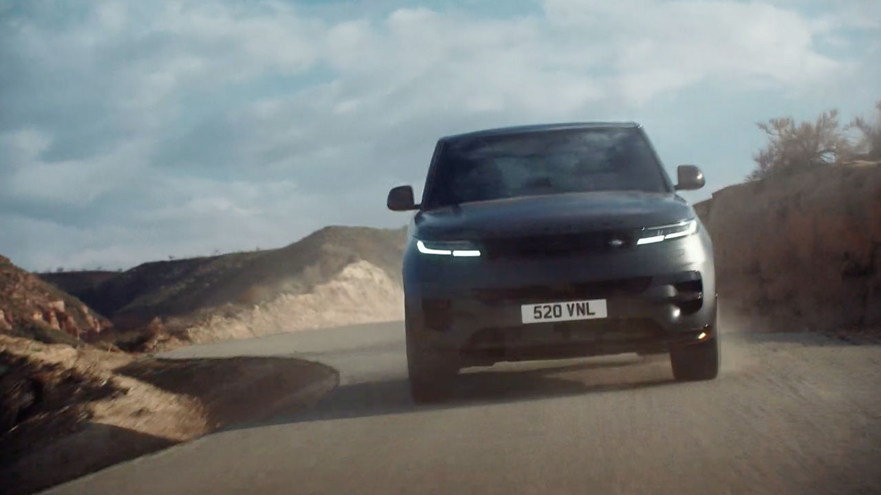 Range Rover Sports driving on hill road