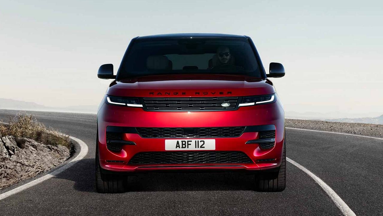 Range Rover Sport (Red) driving on road