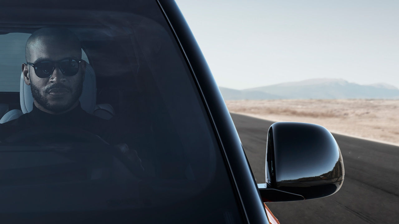 Man driving Range Rover Sport on a road