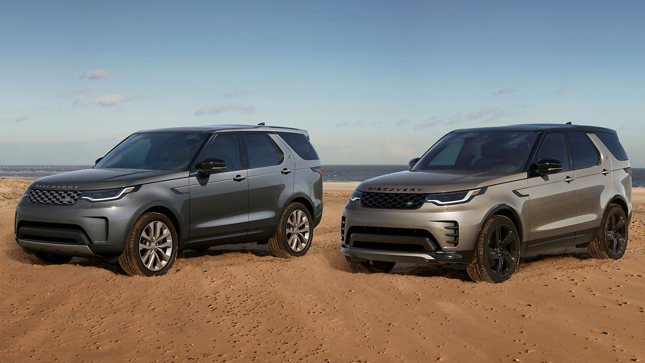 two discovery vehicles on sand