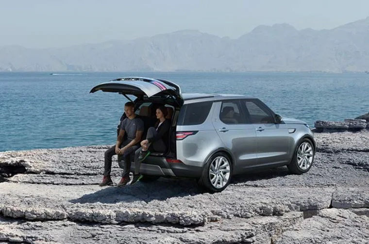 2 people sitting on the boot of car