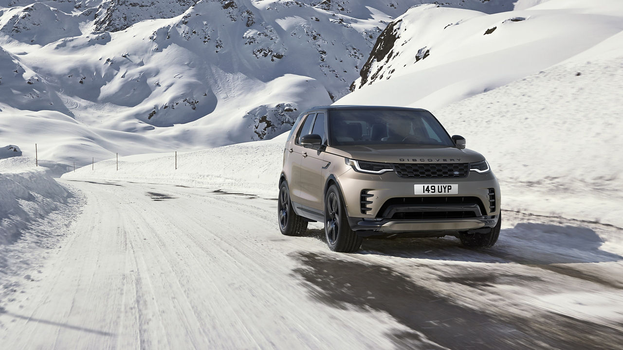 Discovery driving over icy mountain