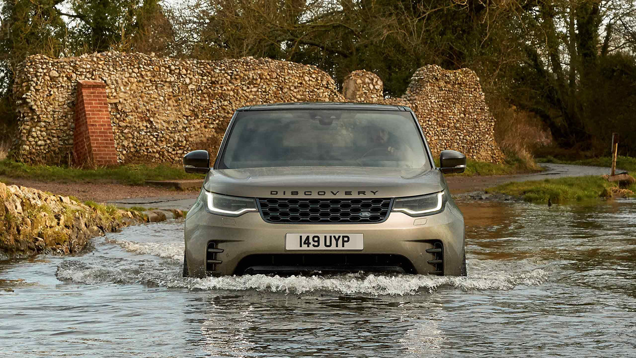 A Discovery driving through water