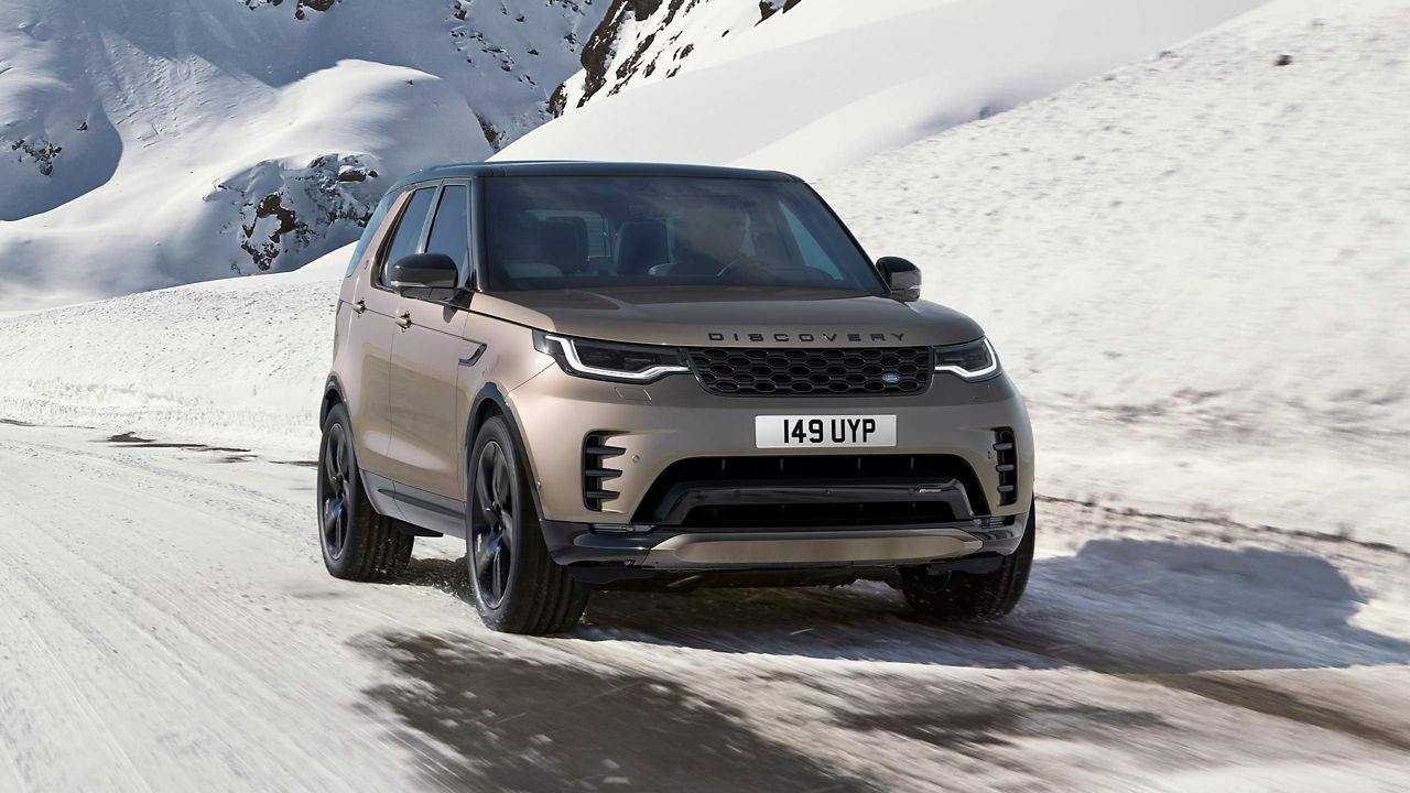 Discovery driving over icy mountain