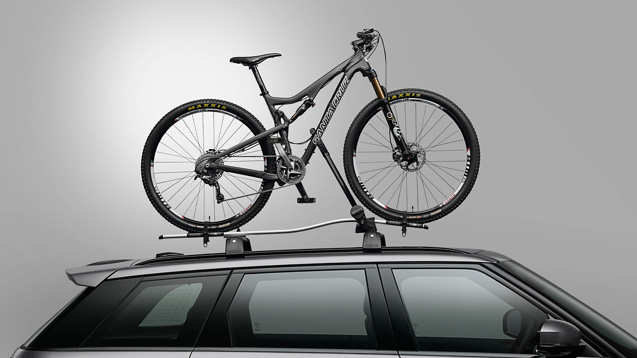 A bike attached to the roof of a car