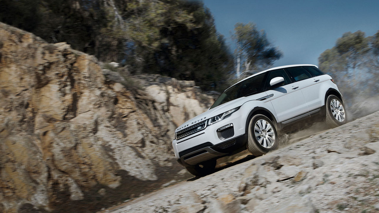 Land Rover driving down rocky hill