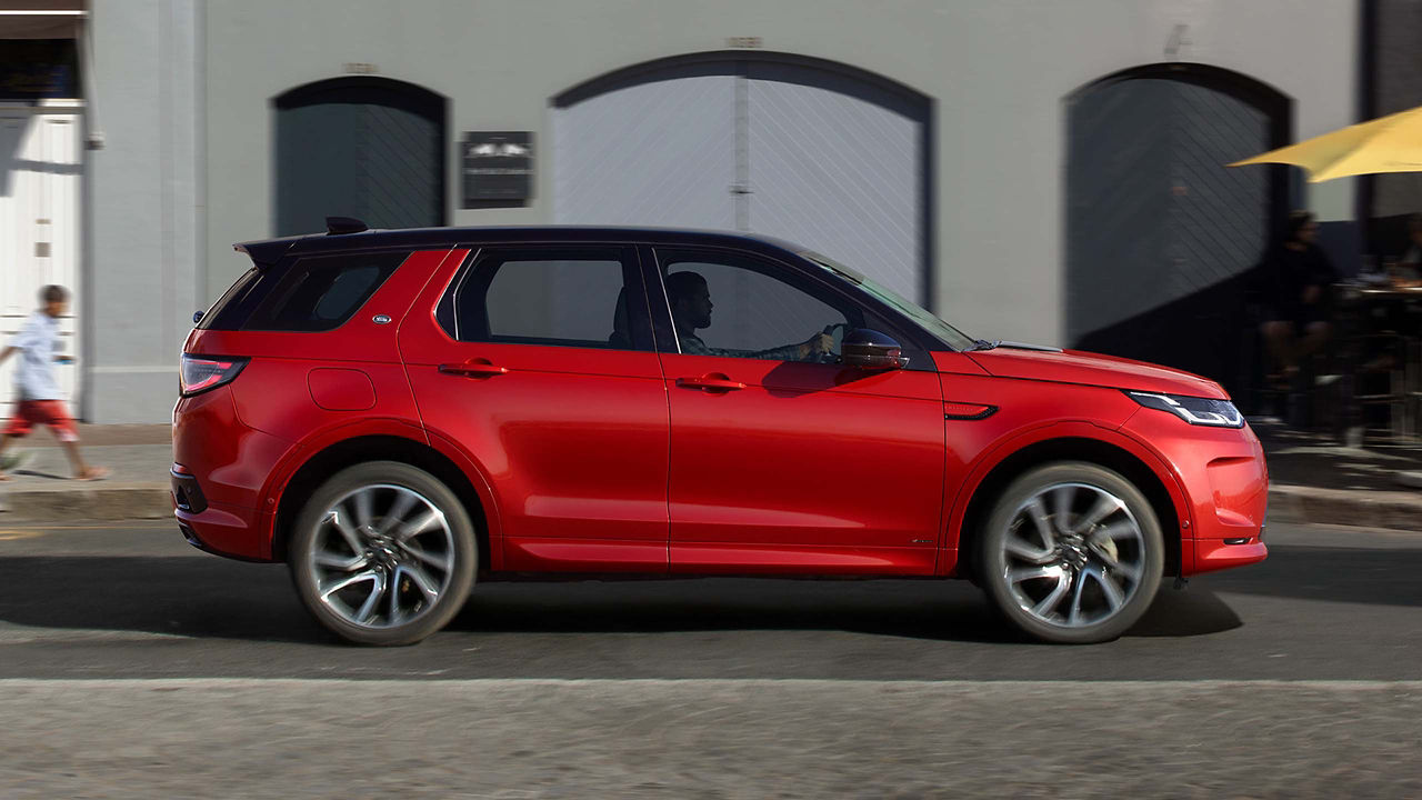 Land Rover Discovery in red profile view