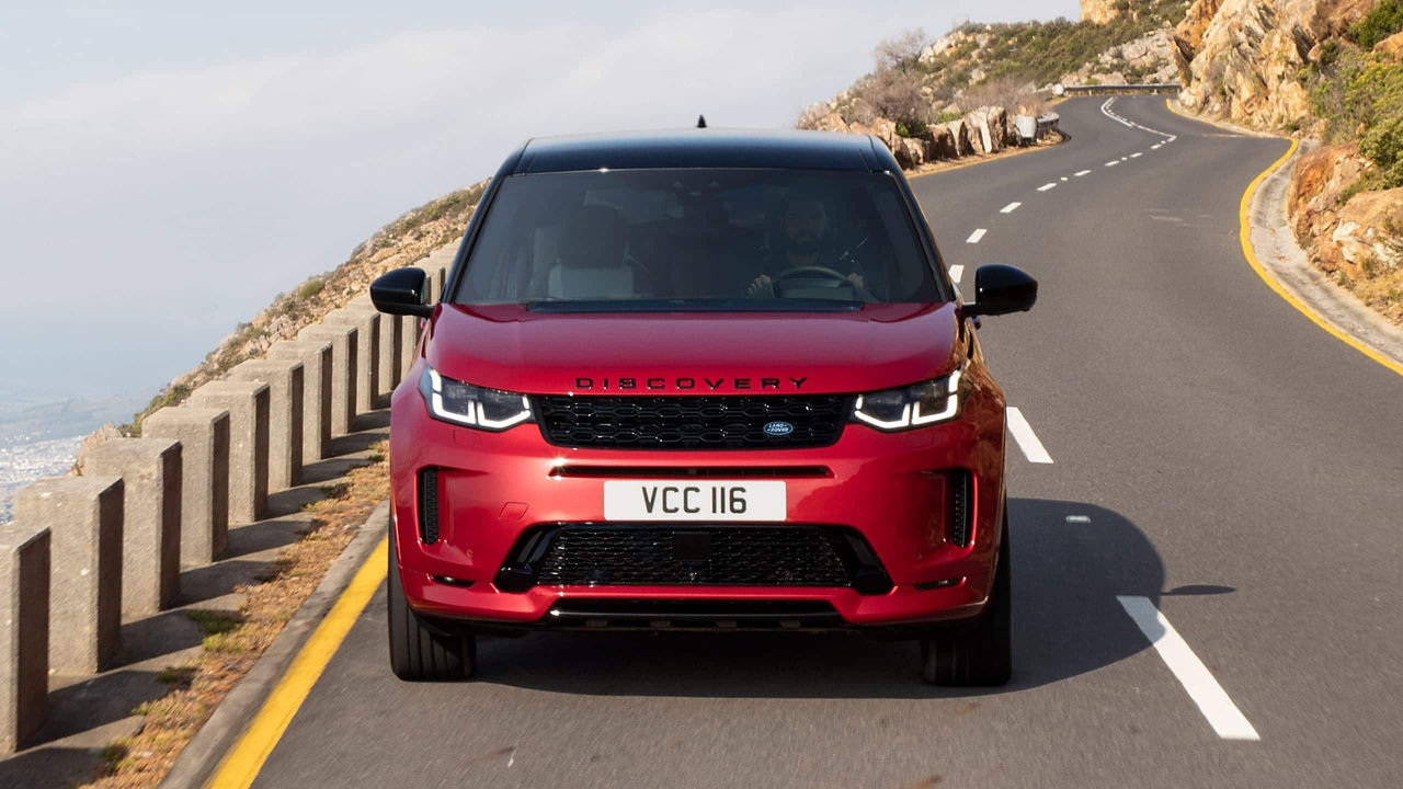 Discovery Sport in Red Driving down the Road