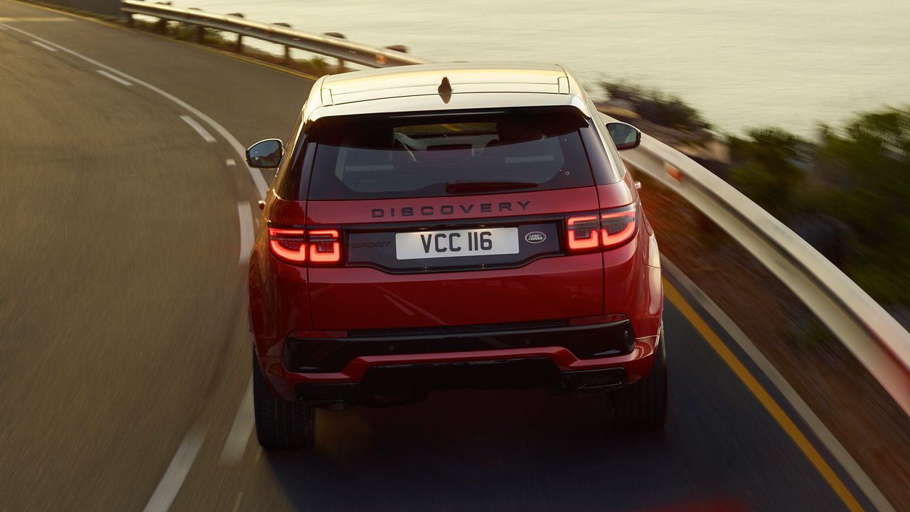 Red Land Rover Discovery on the road