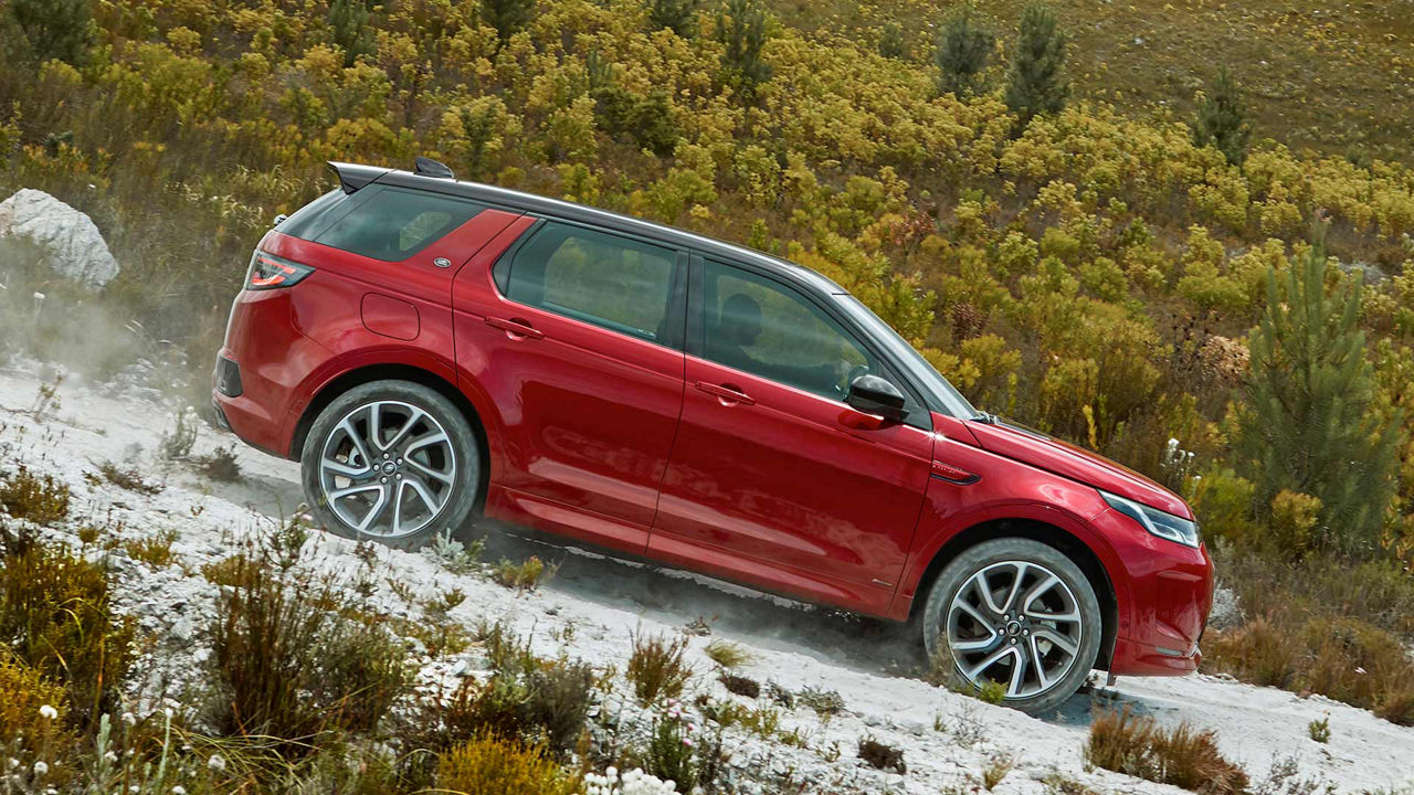 Discovery Sport in red driving down a hill