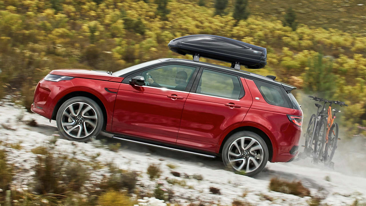 Discovery Sport driving up a Hill with Personalised Accessories