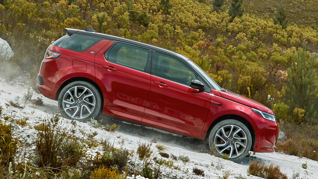 Discovery Sport in Red Driving down the Road