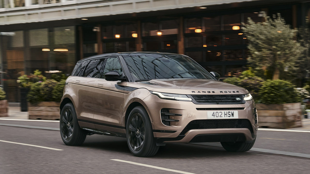 Range Rover Evoque in Corinthian Bronze driving down built up city street