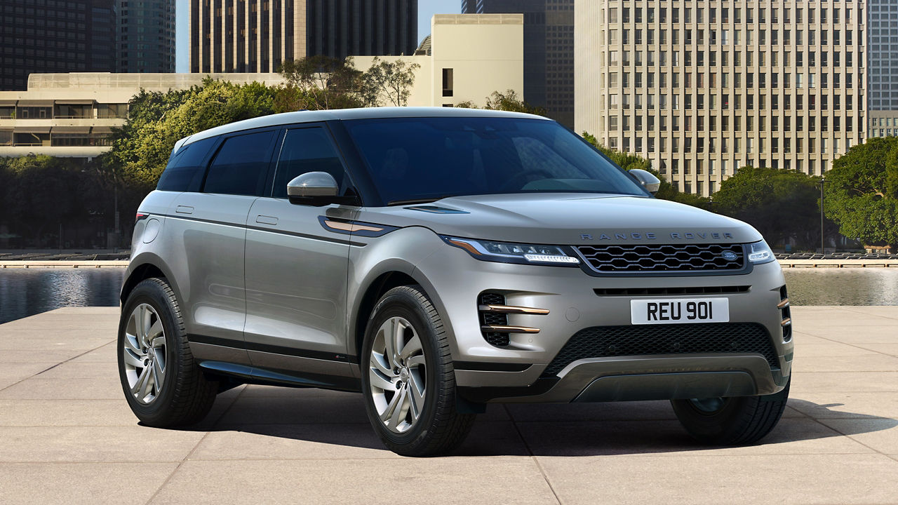 Evoque Parked By Garden Area Against Buildings In City