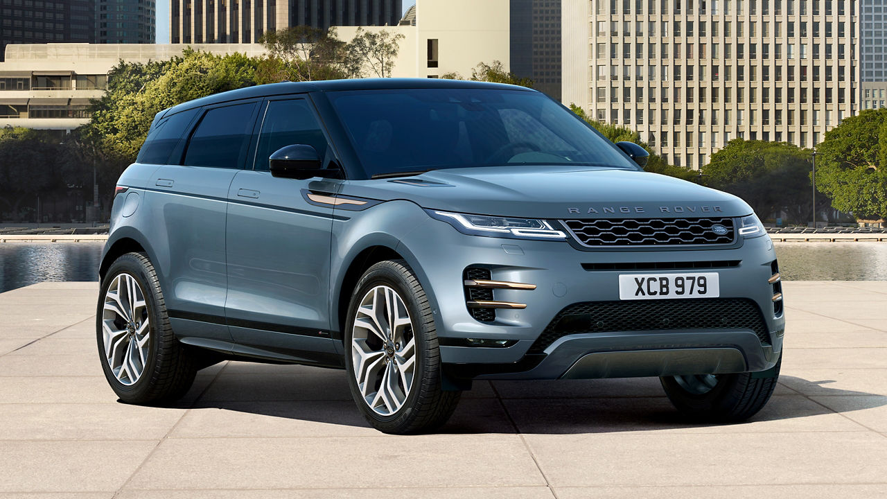 Evoque Parked By Garden Area Against Buildings In City