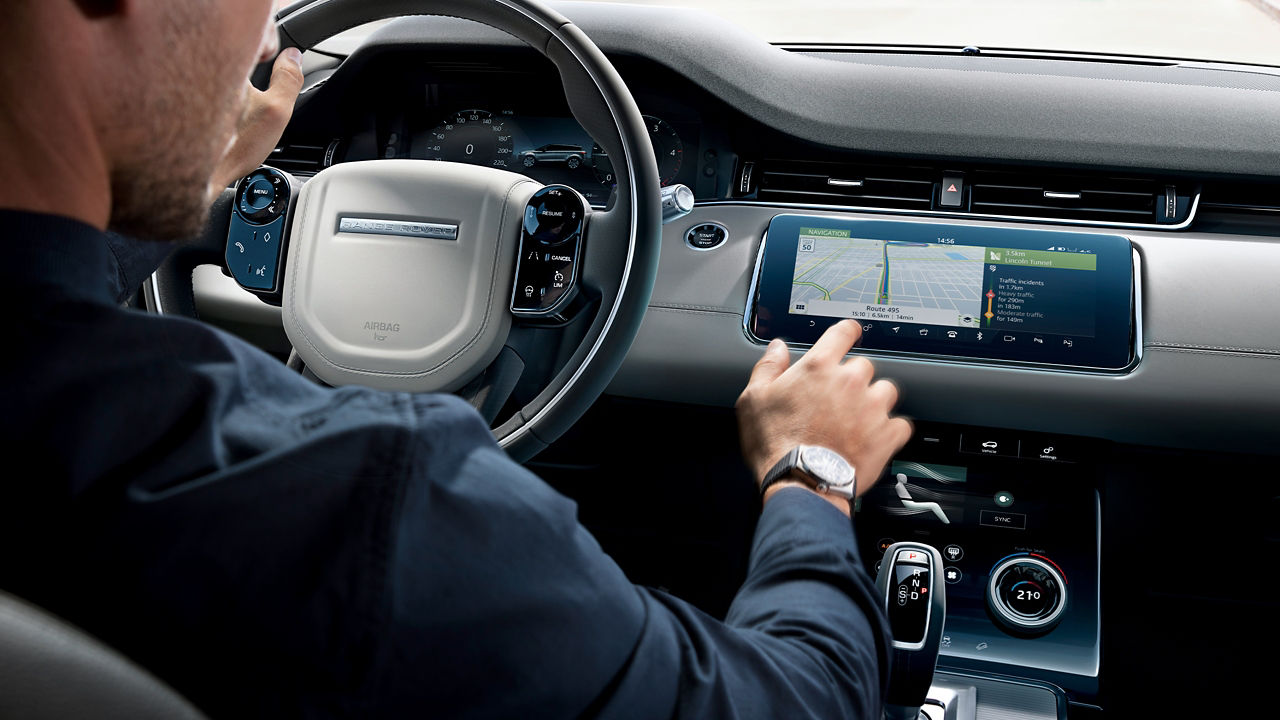 Man Driving A Evoque And Using A Navigation Device