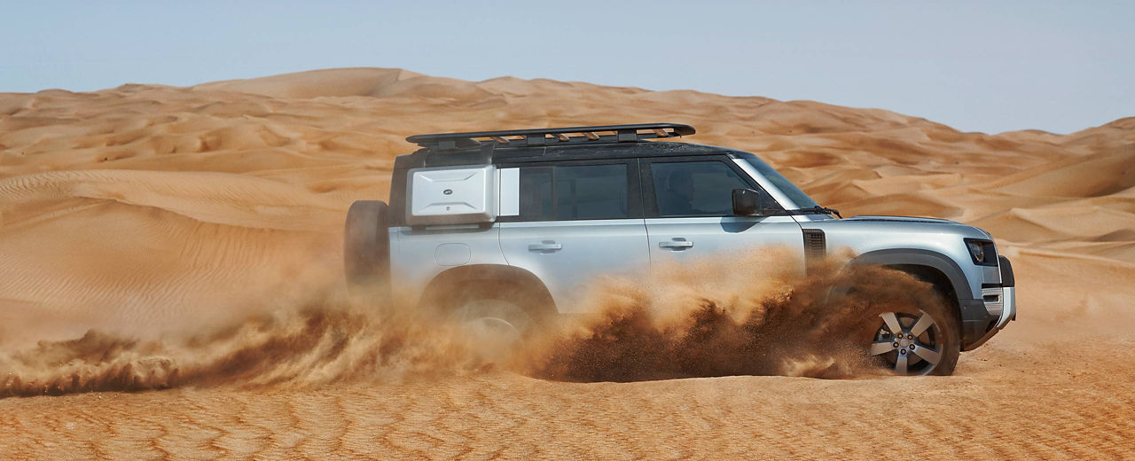 Land Rover Defender driving in the desert