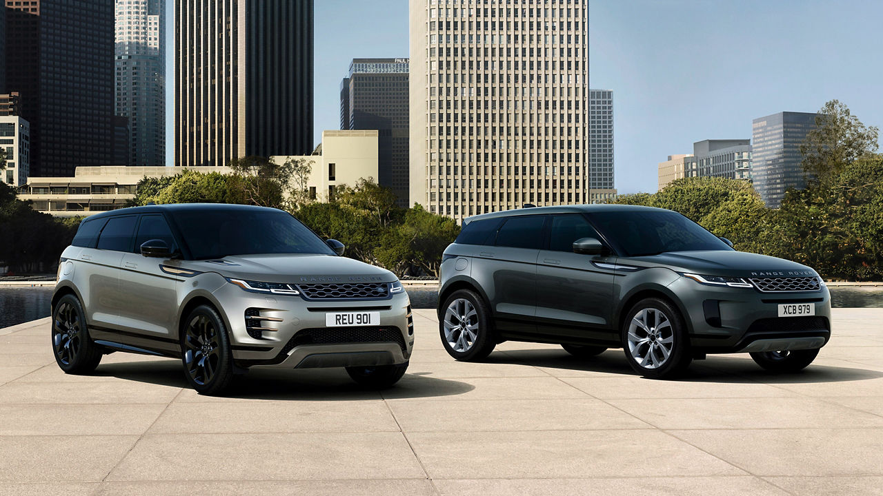 Two Evoque Parked By Garden Area Against Buildings In City