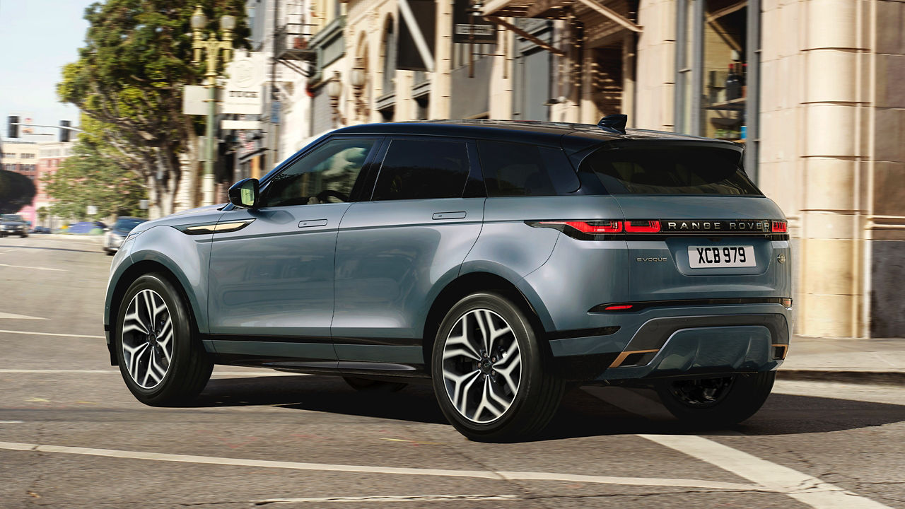 Evoque Car Driving On Asphalt Road Against Buildings