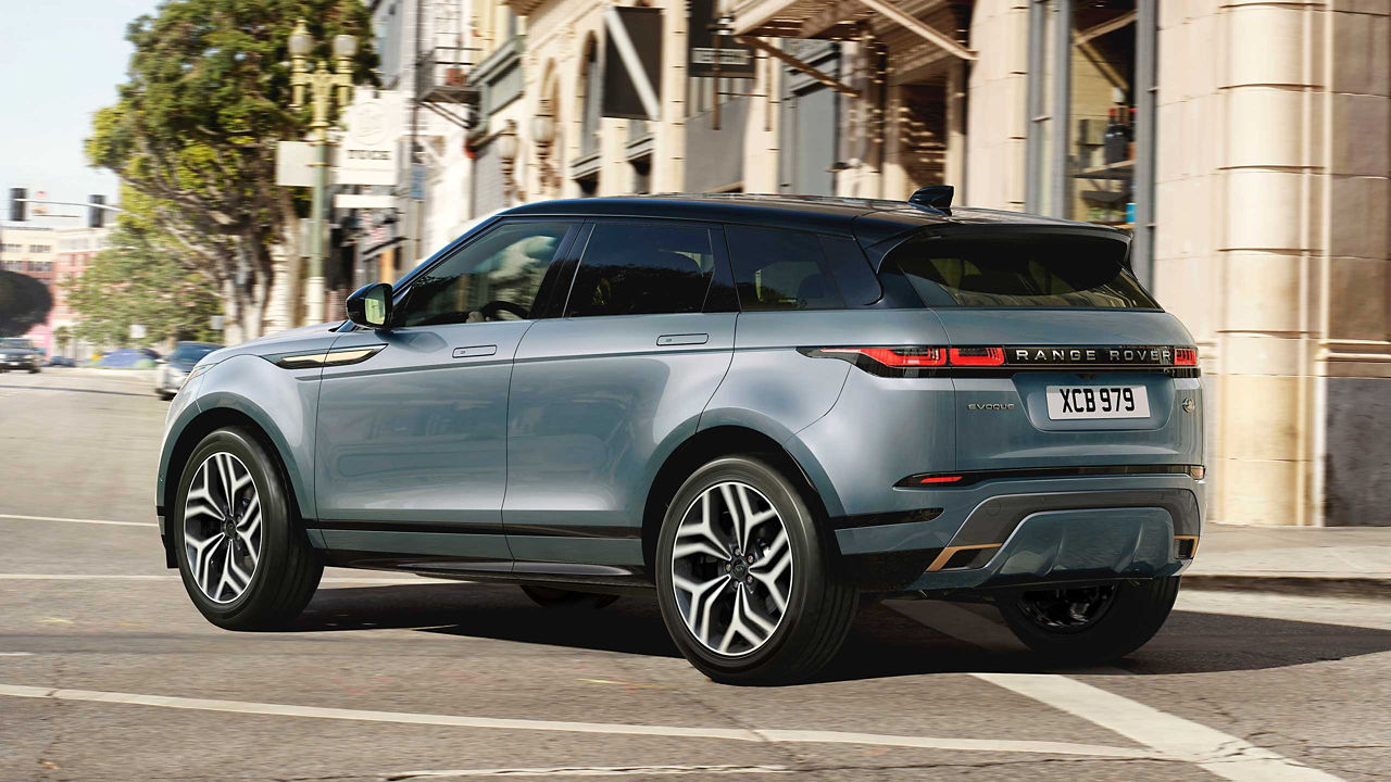 Evoque Car Driving On Asphalt Road Against Buildings