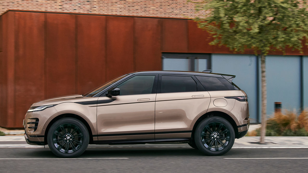 Range Rover Evoque in Corinthian Bronze driving through the streets.