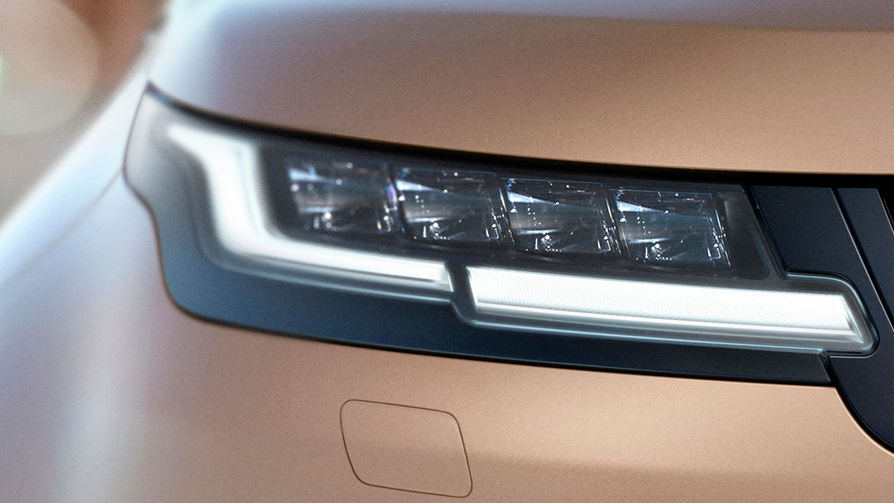 View of Range Rover Evoque’s headlight in Corinthian Bronze.