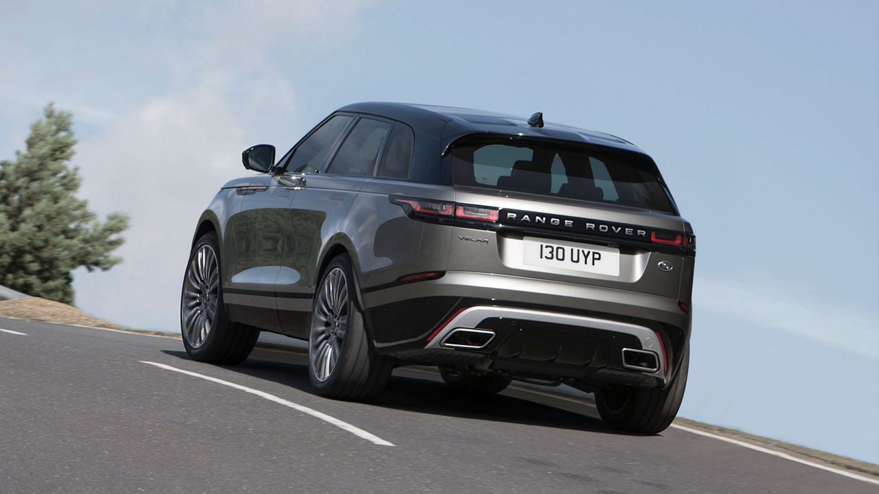 Range Rover Velar in grey driving on the road (rearview)