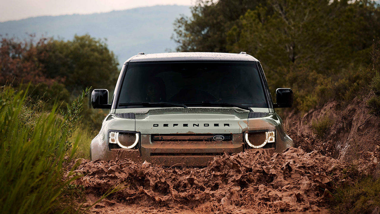Defender driving on mud road