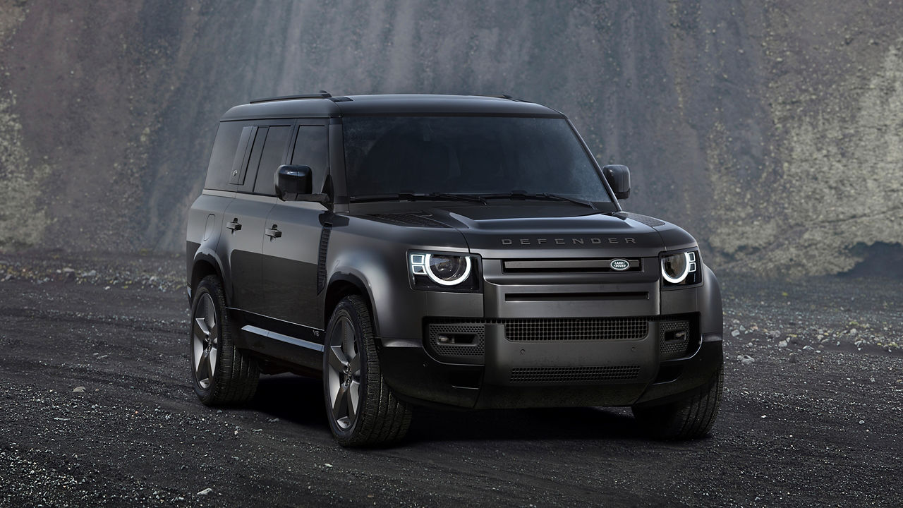 Parked defender on off-road and stone hill background