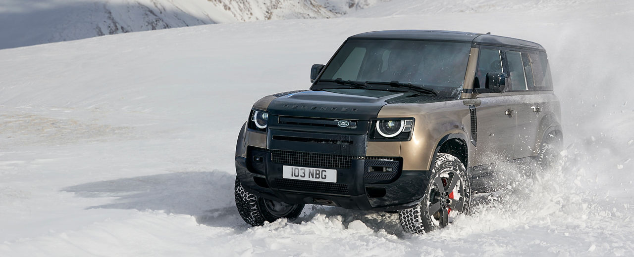 Defender driving on snowy off-road