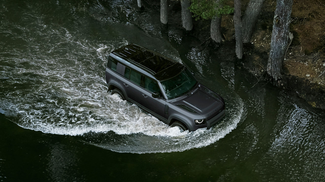 Defender wading through water