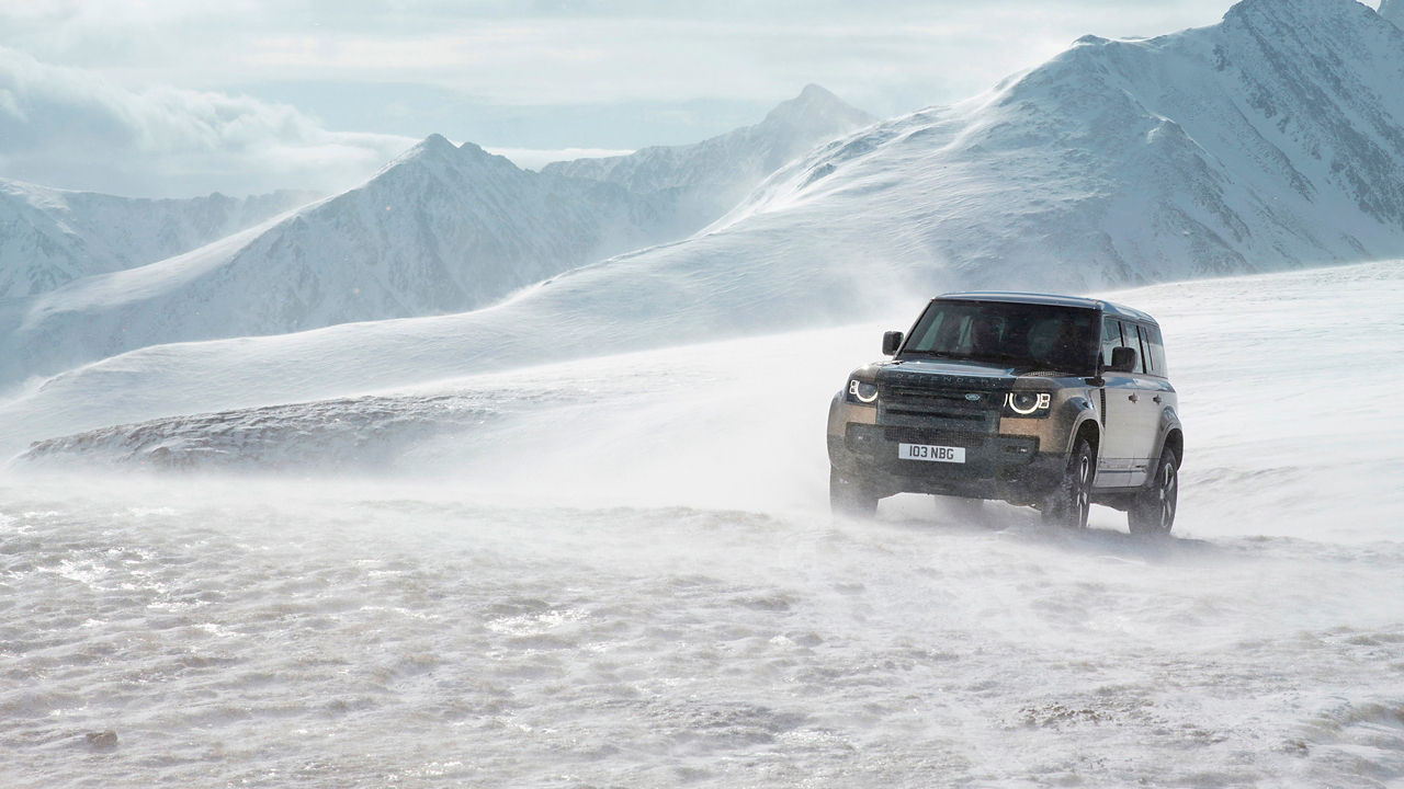 Defender driving on snowy off-road