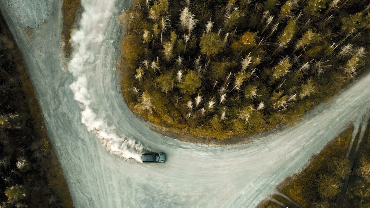 Defender Drifting Over Forest Road